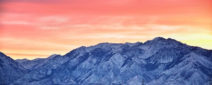 Scenic view of snowcapped mountains against sky during sunset