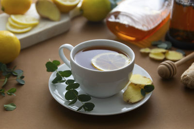 Cup of black tea with ginger and lemon