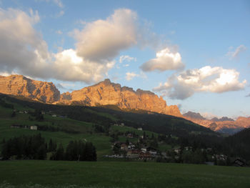 Scenic view of field and mountains against sky