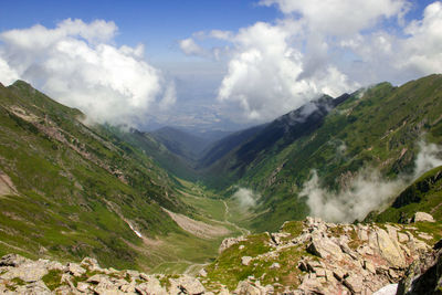Scenic view of valley and mountains against sky