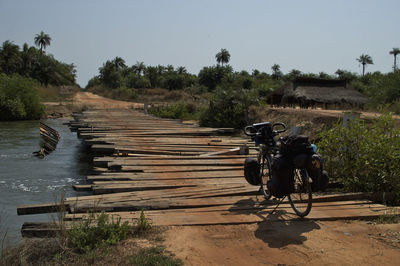 Bicycle on landscape against clear sky