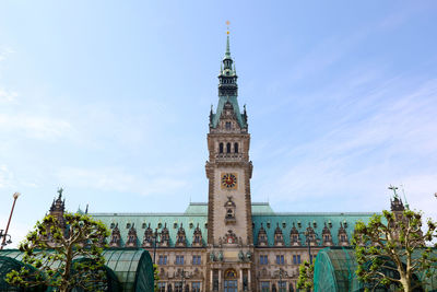 Low angle view of clock tower against sky