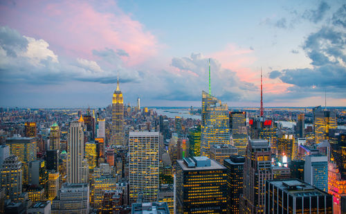 Aerial view of buildings against cloudy sky