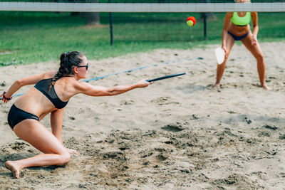 Women playing beach tennis