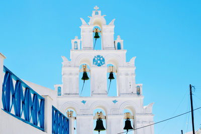 Low angle view of bell tower against clear blue sky