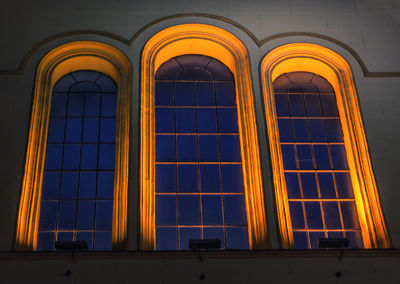 Low angle view of illuminated building against sky