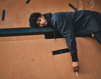 Portrait of young man against wall