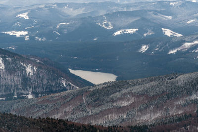 Aerial view of snowcapped mountains against sky