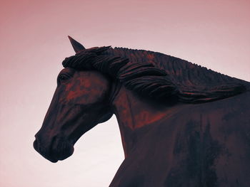 Low angle view of horse statue against clear sky