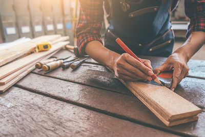 Midsection of man working on table