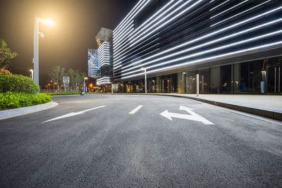 Empty road in city against sky