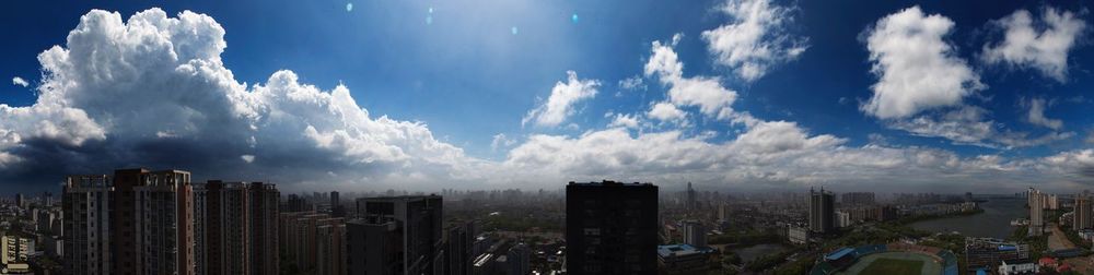 View of cityscape against cloudy sky