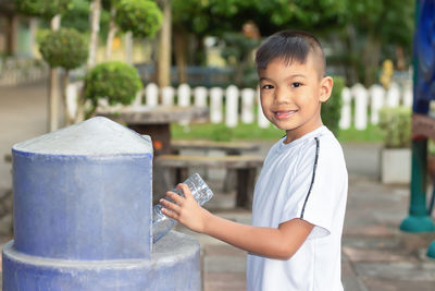 Portrait of smiling boy holding camera