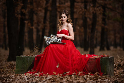 Portrait of woman with red umbrella