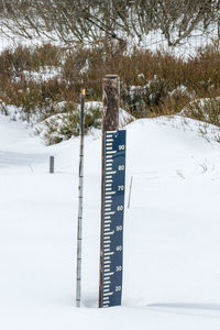 Information sign on snow covered field