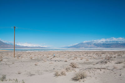 Scenic view of desert against blue sky