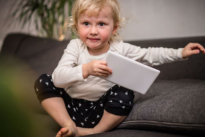 Portrait of boy using digital tablet