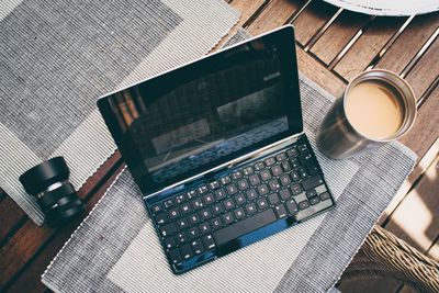 Close-up of open laptop and tea