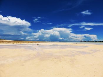 Scenic view of desert against blue sky