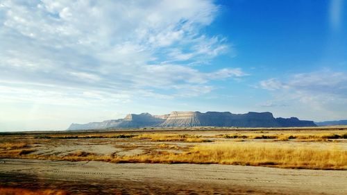 Scenic view of landscape against cloudy sky