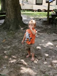 Boy standing on tree trunk