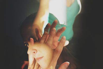 Close-up of hand holding burning candle