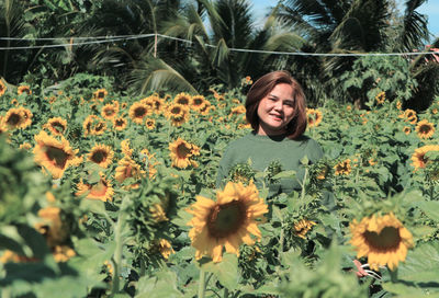 Portrait of smiling young woman on field