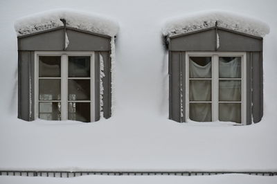 Close-up of snow covered house window
