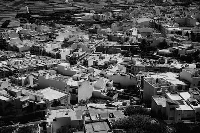 High angle view of houses in town against sky