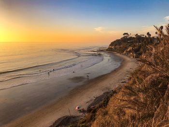 Scenic view of beach against sky during sunset