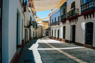 Empty alley amidst buildings in city