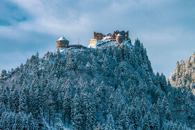 Low angle view of buildings against sky during winter