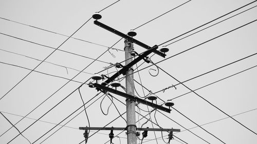 Low angle view of electricity pylon against sky