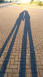 Shadow of people on cobblestone