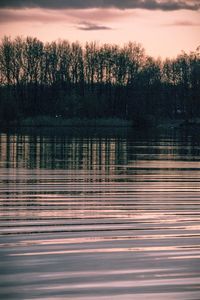 Scenic view of lake against orange sky