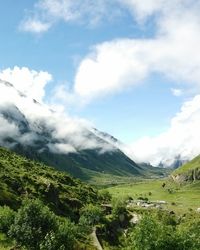 Scenic view of mountains against cloudy sky