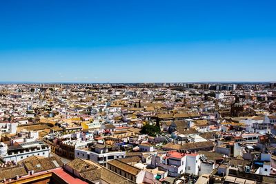 High angle view of townscape against clear blue sky