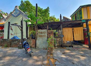 Rear view of man outside house against building