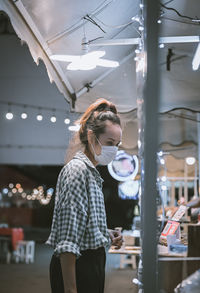 Series photo of young woman tourist wear surgical medical mask touring in street night market