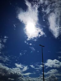 Low angle view of street light against bright sun