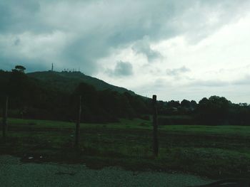 Countryside landscape against cloudy sky