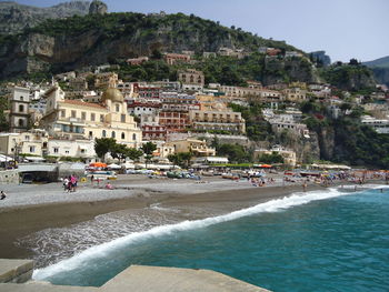 Scenic view of beach by buildings in city