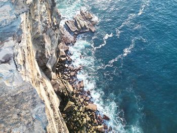 High angle view of rocks on sea