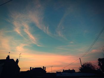 Silhouette buildings against sky during sunset