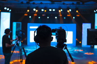 Men photographing at music concert