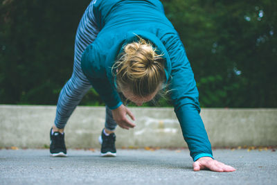 Woman exercising on road