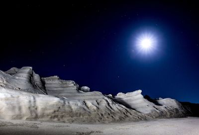 Low angle view of snow against sky at night