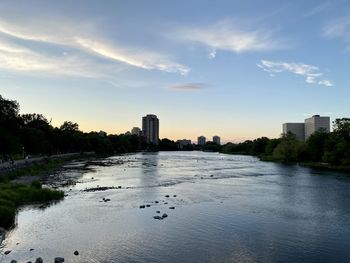 Buildings by sea against sky