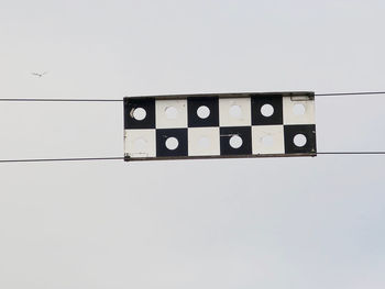 Low angle view of telephone booth against sky