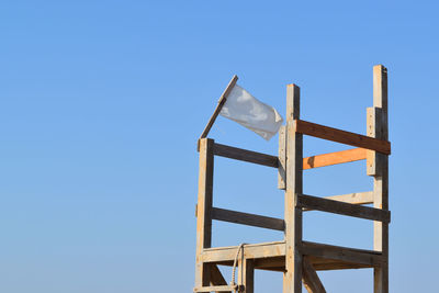 Low angle view of metallic structure against clear blue sky